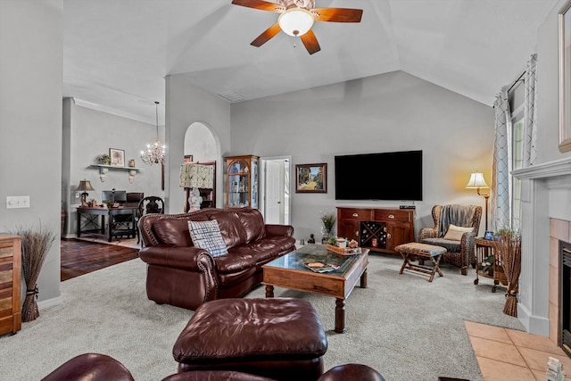 701 E Bayshore Dr, Ozark, MO 65721 - living area featuring carpet floors, ceiling fan, a tiled fireplace, vaulted ceiling, and a chandelier