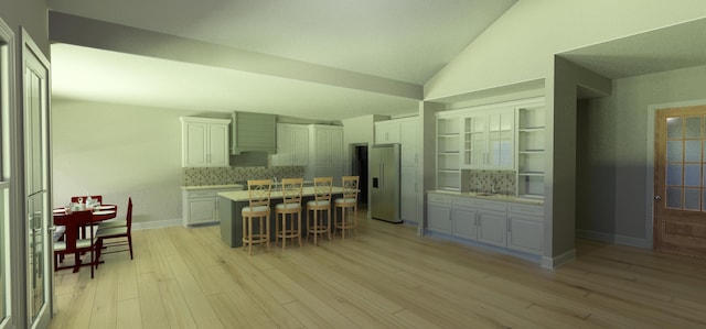2617 W Webb Rd, Ozark, MO 65721 - kitchen with high quality fridge, vaulted ceiling, a breakfast bar, white cabinetry, and tasteful backsplash