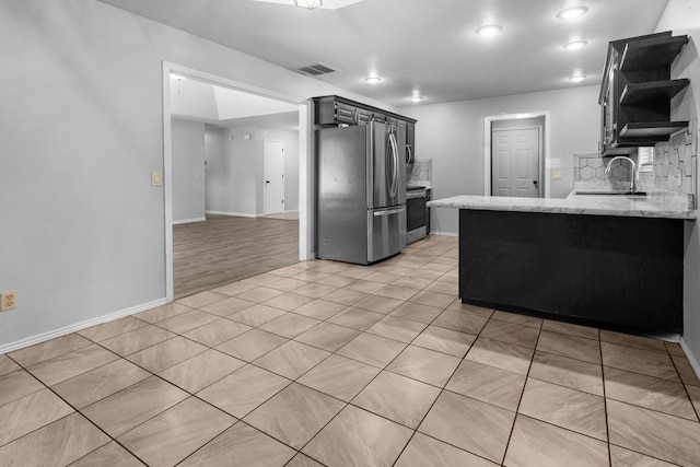 519 N Lynette Ave, Republic, MO 65738 - kitchen with appliances with stainless steel finishes, open shelves, light stone countertops, light tile patterned flooring, and a peninsula
