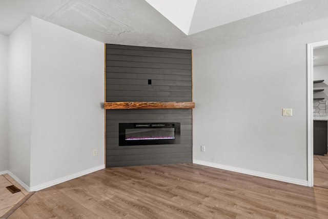 519 N Lynette Ave, Republic, MO 65738 - unfurnished living room featuring a large fireplace and wood finished floors