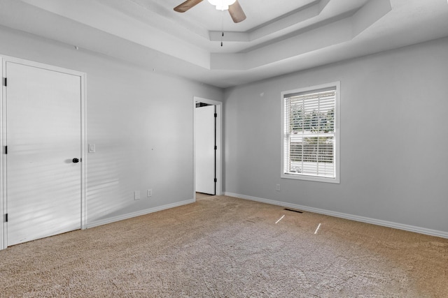 519 N Lynette Ave, Republic, MO 65738 - unfurnished bedroom with a tray ceiling, carpet floors, and a ceiling fan