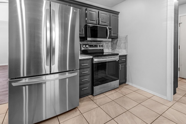 519 N Lynette Ave, Republic, MO 65738 - kitchen featuring appliances with stainless steel finishes, decorative backsplash, light tile patterned floors, and gray cabinets