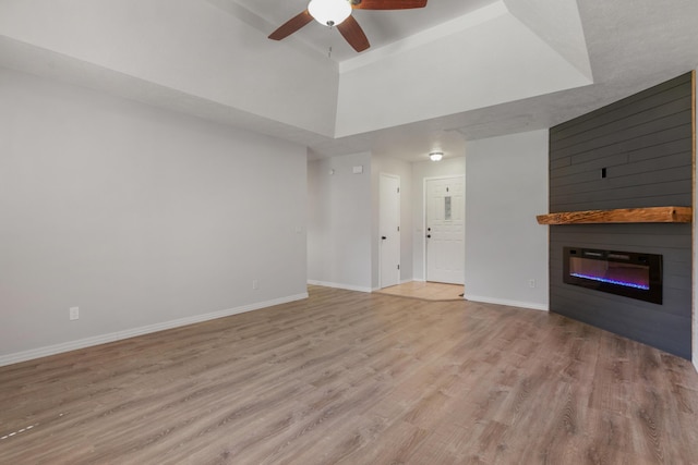 519 N Lynette Ave, Republic, MO 65738 - unfurnished living room with a large fireplace, wood finished floors, and a ceiling fan