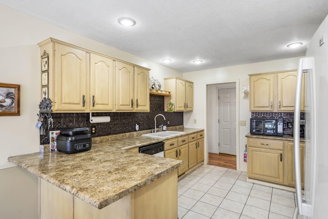 3045 S Palisades Dr, Springfield, MO 65807 - kitchen with light brown cabinets, a peninsula, backsplash, freestanding refrigerator, and a textured ceiling