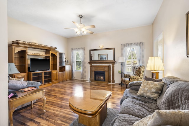 3045 S Palisades Dr, Springfield, MO 65807 - living room featuring a ceiling fan, wood finished floors, and a fireplace with flush hearth
