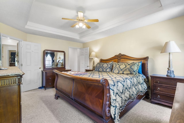3045 S Palisades Dr, Springfield, MO 65807 - bedroom featuring light colored carpet, a raised ceiling, and a ceiling fan