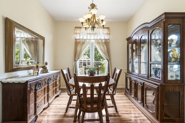 3045 S Palisades Dr, Springfield, MO 65807 - dining area featuring a chandelier and light wood-style flooring