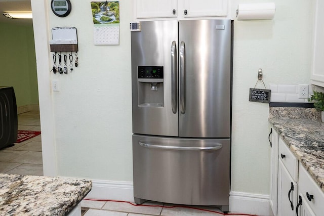 628 W Lynn St, Springfield, MO 65802 - kitchen featuring stainless steel refrigerator with ice dispenser, white cabinetry, light stone counters, and light tile patterned flooring