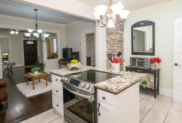 628 W Lynn St, Springfield, MO 65802 - kitchen with stainless steel range with electric stovetop, a chandelier, white cabinetry, light stone countertops, and ornamental molding