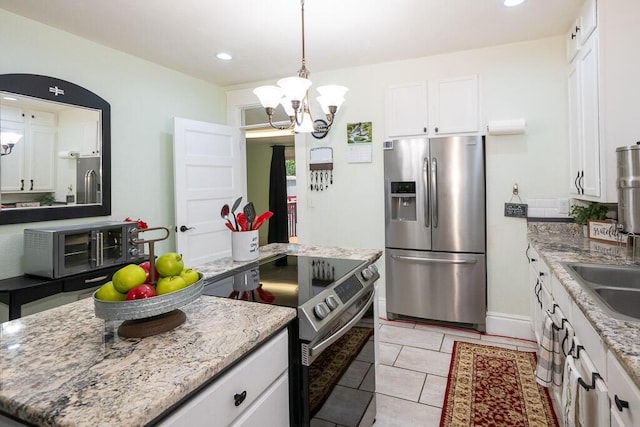 628 W Lynn St, Springfield, MO 65802 - kitchen featuring stainless steel appliances, a chandelier, white cabinetry, hanging light fixtures, and recessed lighting