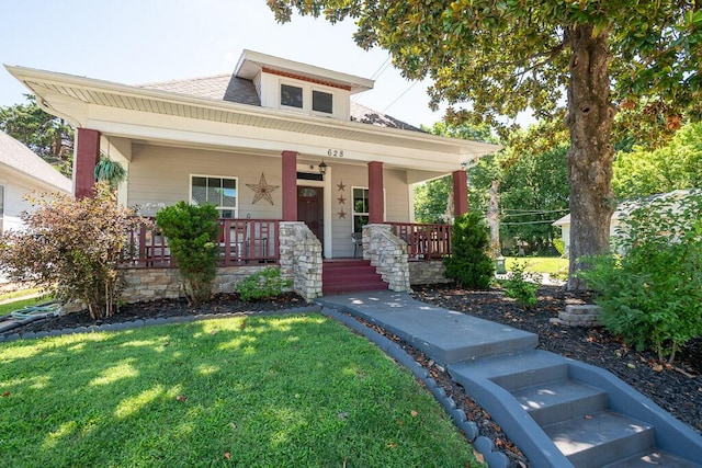 628 W Lynn St, Springfield, MO 65802 - bungalow featuring a front lawn, a porch, and a shingled roof
