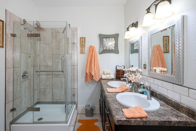 628 W Lynn St, Springfield, MO 65802 - bathroom with double vanity, a stall shower, and tasteful backsplash