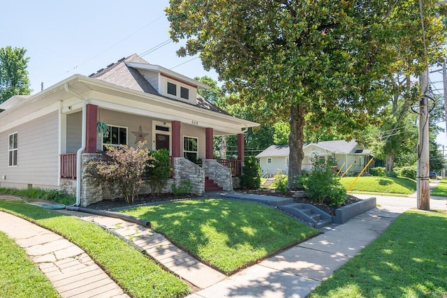 628 W Lynn St, Springfield, MO 65802 - bungalow-style house with a front lawn, a porch, and stone siding
