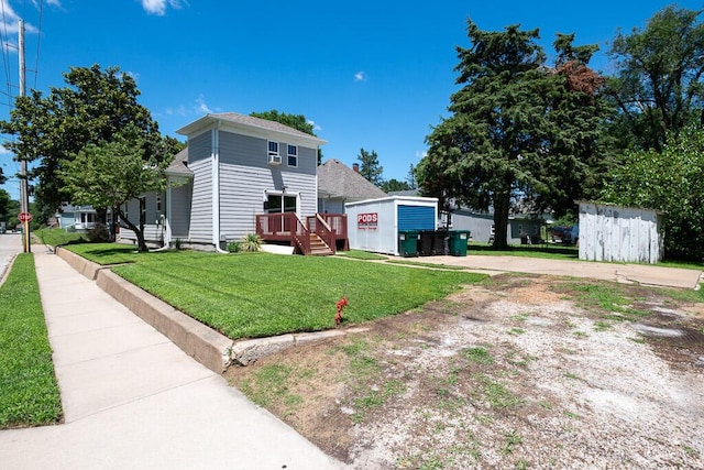 628 W Lynn St, Springfield, MO 65802 - view of property exterior with a lawn, a deck, and driveway