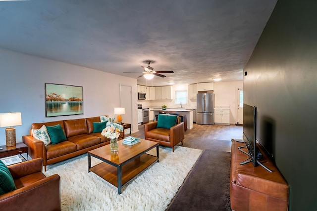 1520 E Seminole St, Springfield, MO 65804 - living room featuring a ceiling fan and dark colored carpet