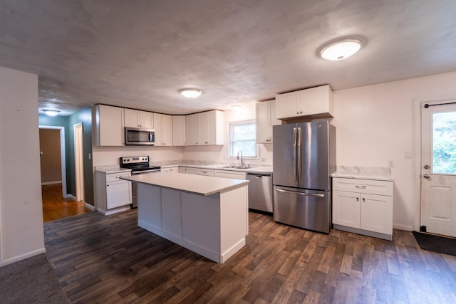 1520 E Seminole St, Springfield, MO 65804 - kitchen with appliances with stainless steel finishes, light countertops, a kitchen island, and white cabinetry