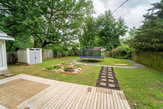 1520 E Seminole St, Springfield, MO 65804 - wooden terrace with a storage unit, a trampoline, and a fenced backyard
