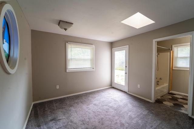 1520 E Seminole St, Springfield, MO 65804 - unfurnished bedroom with a skylight, carpet flooring, ensuite bath, and access to exterior