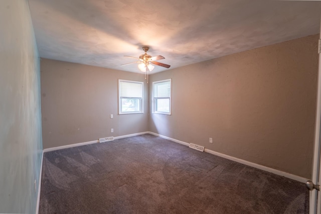 1520 E Seminole St, Springfield, MO 65804 - spare room with ceiling fan and dark carpet