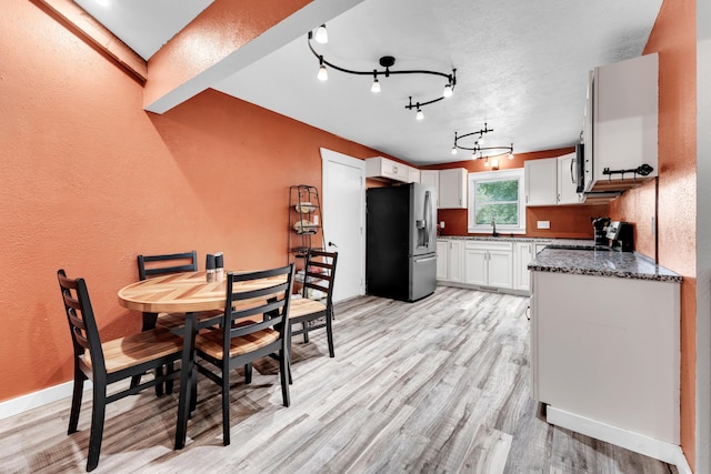 1604 E Sycamore St, Ozark, MO 65721 - dining room featuring a textured wall and light wood-type flooring