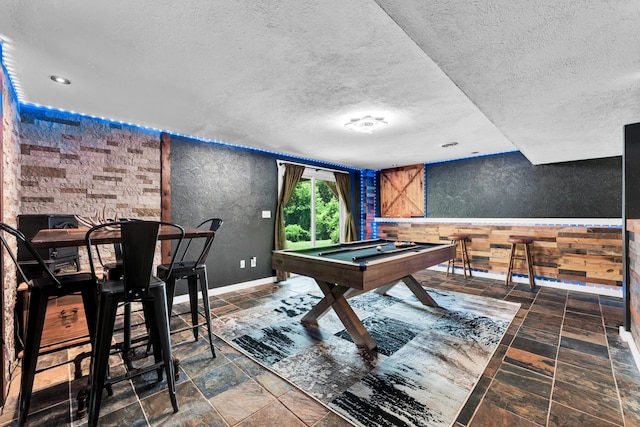 1604 E Sycamore St, Ozark, MO 65721 - recreation room with a textured ceiling, stone finish flooring, billiards, and a textured wall
