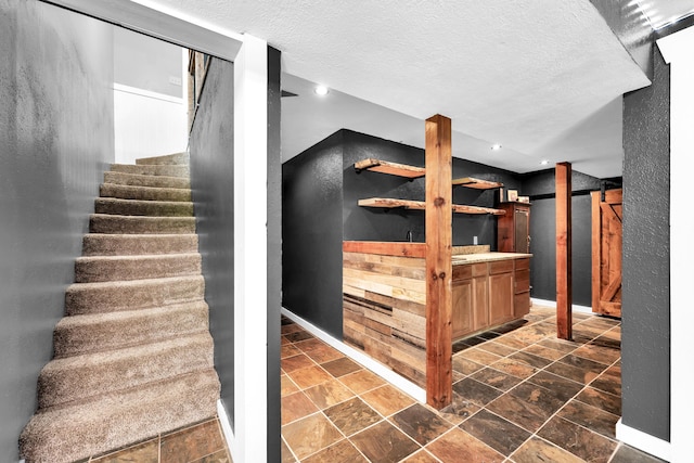 1604 E Sycamore St, Ozark, MO 65721 - stairway with stone tile floors, a textured ceiling, and recessed lighting