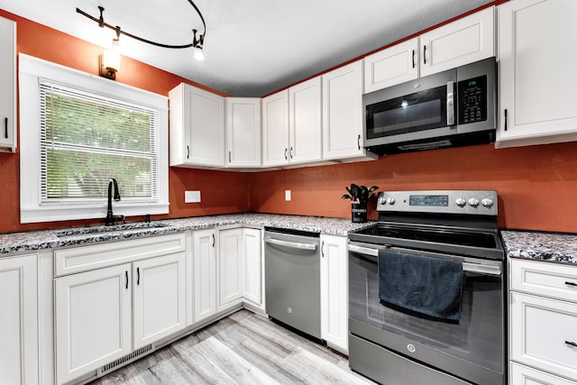 1604 E Sycamore St, Ozark, MO 65721 - kitchen with stainless steel appliances, white cabinets, and light stone counters
