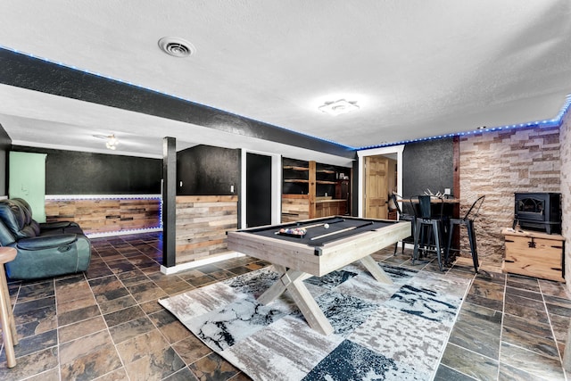 1604 E Sycamore St, Ozark, MO 65721 - playroom with wooden walls, a textured ceiling, a wood stove, pool table, and wainscoting
