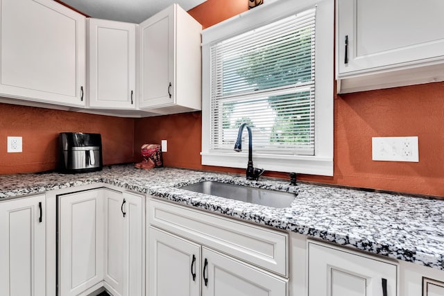1604 E Sycamore St, Ozark, MO 65721 - kitchen with white cabinets and light stone countertops