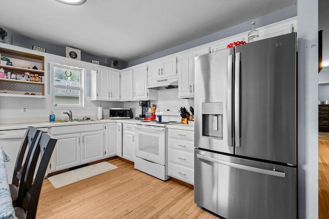 1860 E Division St, Bolivar, MO 65613 - kitchen featuring stainless steel appliances, under cabinet range hood, light countertops, and light wood finished floors
