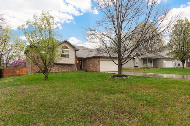 3239 W Erie St, Springfield, MO 65807 - tri-level home featuring driveway, an attached garage, and brick siding