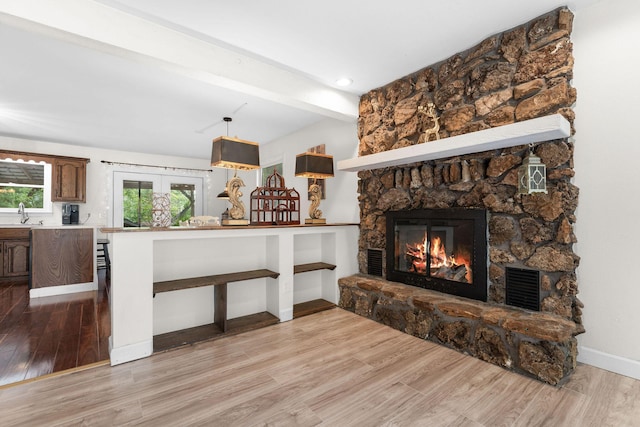 189 Pierce Pl, Forsyth, MO 65653 - living room with a fireplace, wood finished floors, beamed ceiling, and french doors