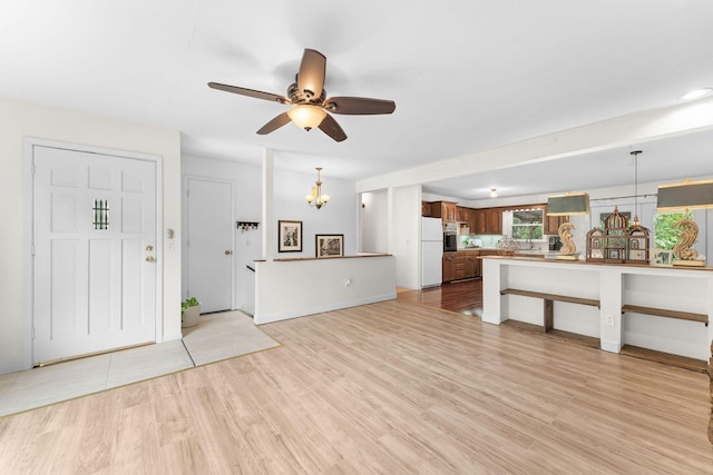 189 Pierce Pl, Forsyth, MO 65653 - unfurnished living room featuring ceiling fan, light wood-style flooring, and a chandelier