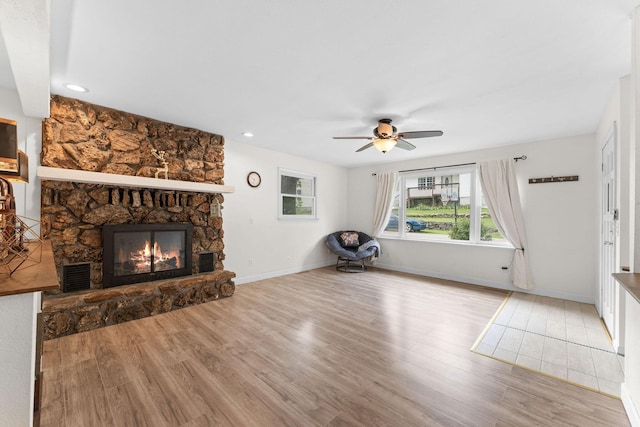 189 Pierce Pl, Forsyth, MO 65653 - unfurnished living room featuring wood finished floors, a stone fireplace, ceiling fan, and recessed lighting