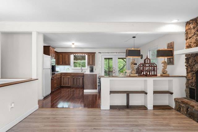 189 Pierce Pl, Forsyth, MO 65653 - kitchen with dark wood-style flooring, light countertops, freestanding refrigerator, french doors, and pendant lighting