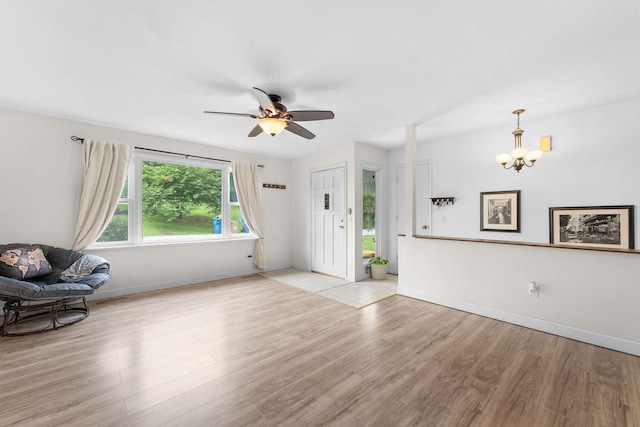 189 Pierce Pl, Forsyth, MO 65653 - unfurnished living room with a chandelier, a ceiling fan, and light wood-type flooring