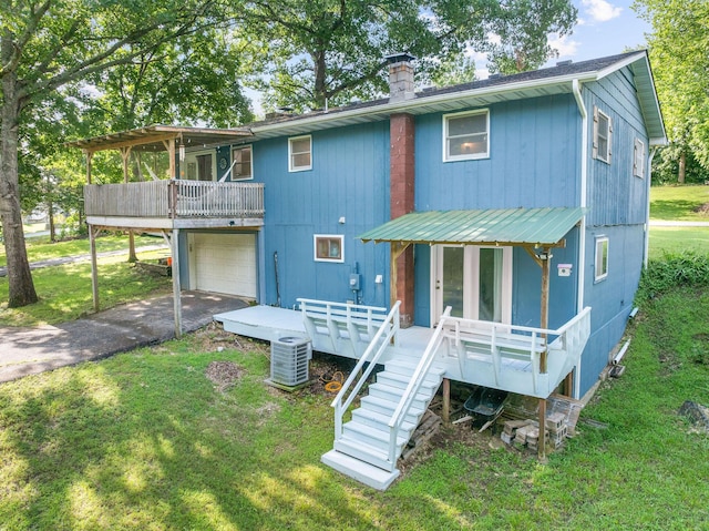 189 Pierce Pl, Forsyth, MO 65653 - back of property featuring asphalt driveway, a deck, a lawn, a garage, and stairway