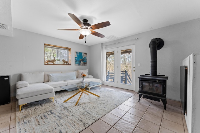 189 Pierce Pl, Forsyth, MO 65653 - living room with a wood stove, ceiling fan, and light tile patterned floors