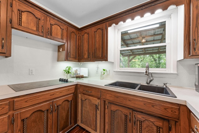 189 Pierce Pl, Forsyth, MO 65653 - kitchen with black electric stovetop, light countertops, and brown cabinetry