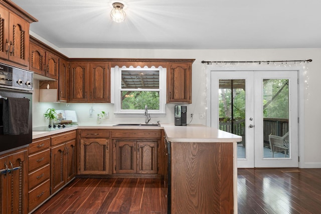 189 Pierce Pl, Forsyth, MO 65653 - kitchen featuring wall oven, french doors, dark wood finished floors, a peninsula, and light countertops