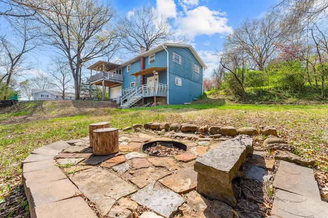 189 Pierce Pl, Forsyth, MO 65653 - rear view of property with an outdoor fire pit, a deck, stairs, and a chimney