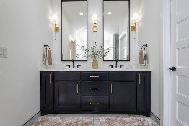 2112 N Sun Valley Dr, Springfield, MO 65802 - bathroom with double vanity, marble look tile flooring, and recessed lighting