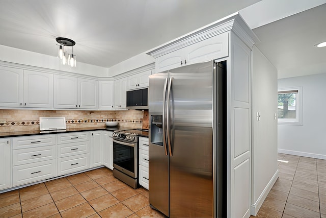 1923 S Cedarbrook Ave, Springfield, MO 65804 - kitchen with stainless steel appliances, light tile patterned floors, dark countertops, and backsplash