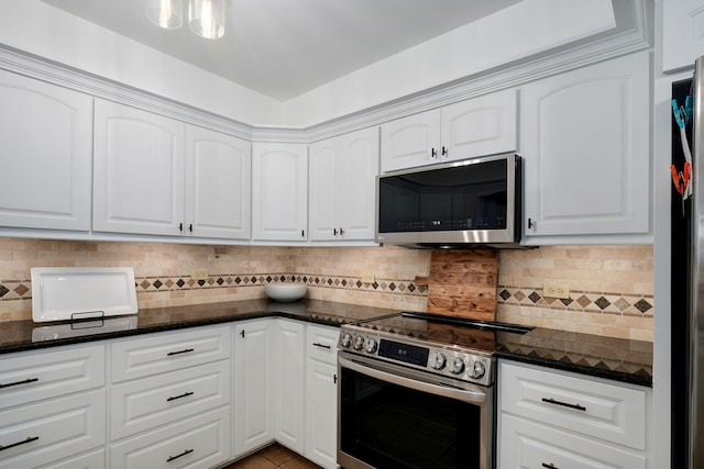 1923 S Cedarbrook Ave, Springfield, MO 65804 - kitchen with appliances with stainless steel finishes, dark stone counters, white cabinets, and tasteful backsplash