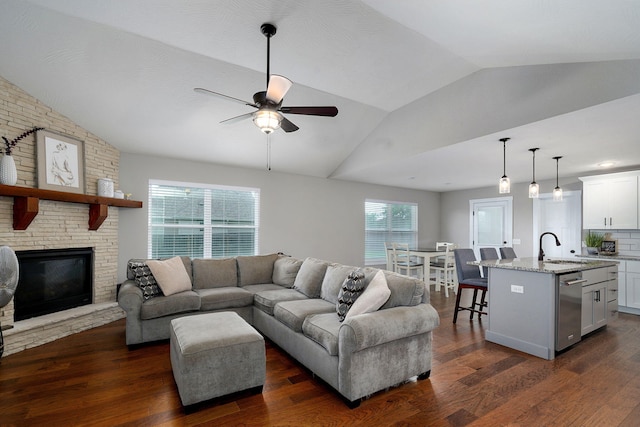 917 W Charlotte St, Republic, MO 65738 - living room with lofted ceiling, ceiling fan, dark wood-style floors, and a fireplace
