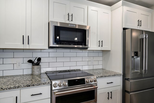 917 W Charlotte St, Republic, MO 65738 - kitchen featuring stainless steel appliances, white cabinetry, tasteful backsplash, and light stone counters