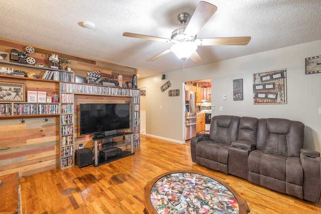 11240 State Hwy E, Rolla, MO 65401 - living room featuring a ceiling fan, wood finished floors, and a textured ceiling