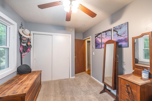 11240 State Hwy E, Rolla, MO 65401 - carpeted bedroom with a textured ceiling, a closet, and ceiling fan