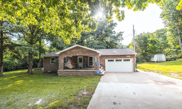 11240 State Hwy E, Rolla, MO 65401 - view of front of property with covered porch, a garage, brick siding, concrete driveway, and a front lawn