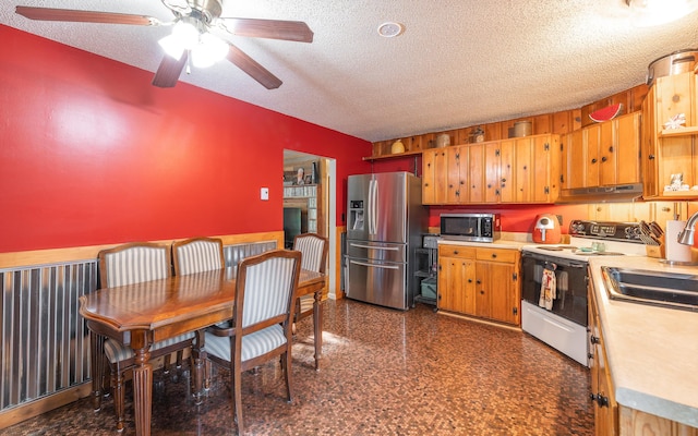 11240 State Hwy E, Rolla, MO 65401 - kitchen with appliances with stainless steel finishes, a textured ceiling, under cabinet range hood, light countertops, and ceiling fan